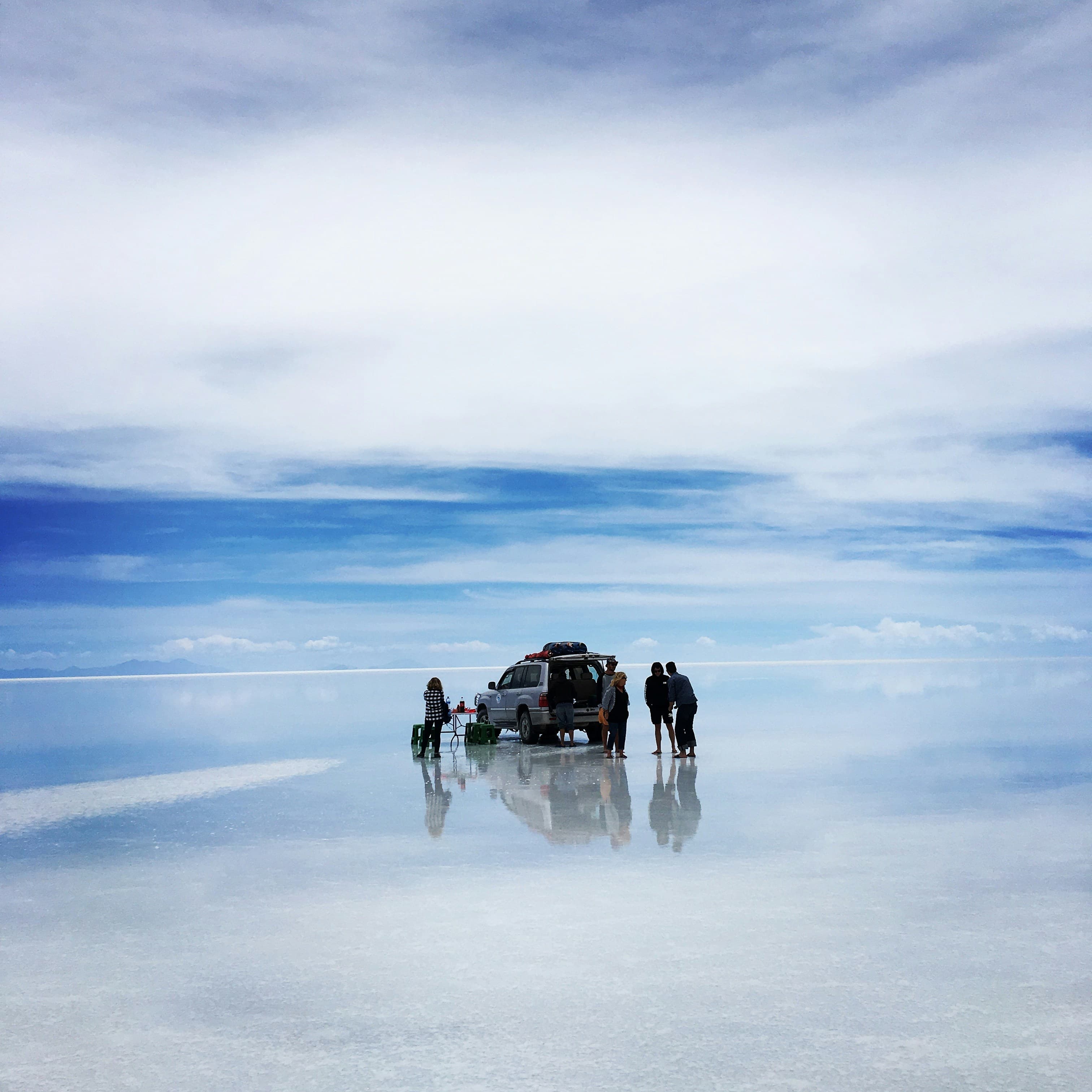 Sunrise over Salar de Uyuni creating perfect mirror reflection